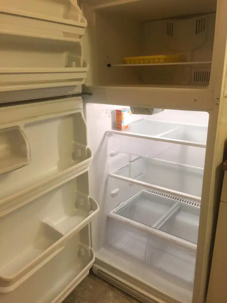 Full-sized refrigerator with top freezer.